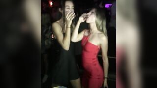 Friends kissing at a party